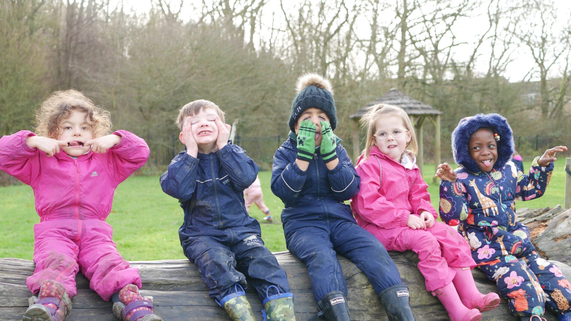 pupils playing around in woodlands adventure at eyfs at cliffe woods primary school