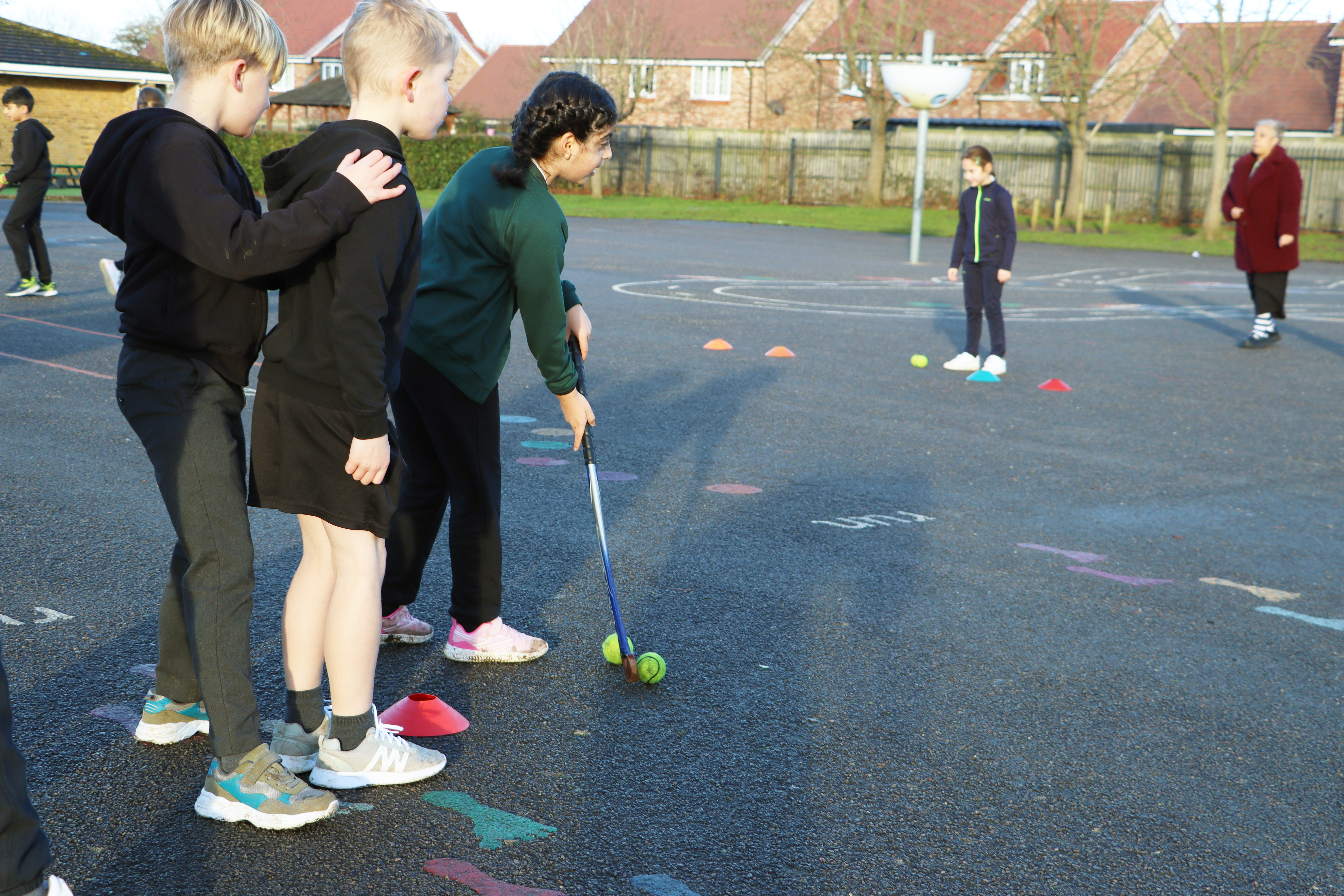 pupils playing hockey in pe lessons